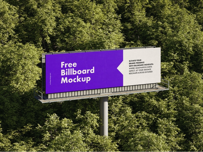 Billboard pomiędzy drzewami.